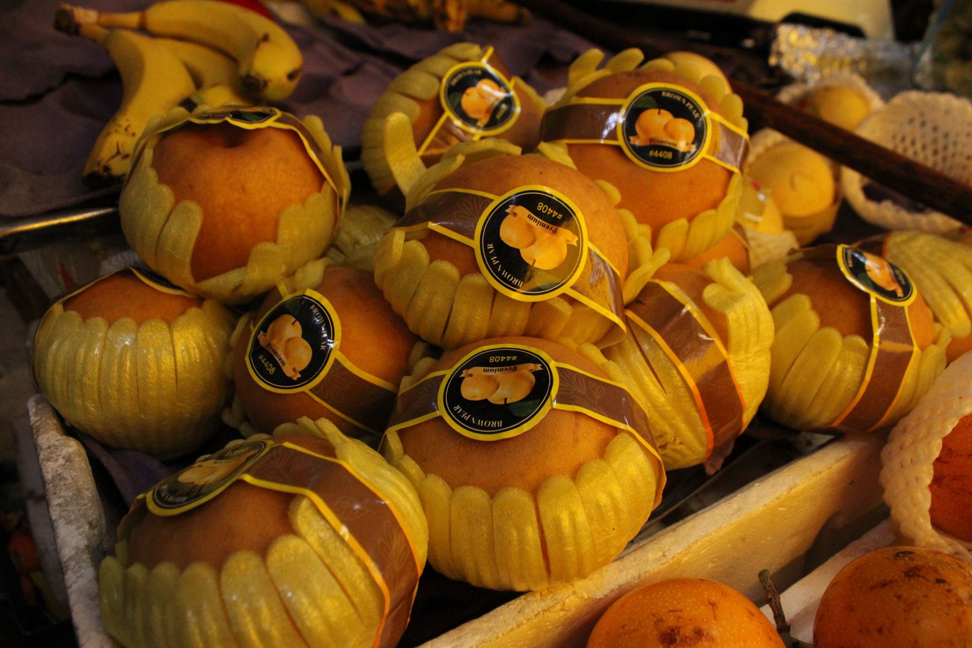 Wrapped fruit at a market stall