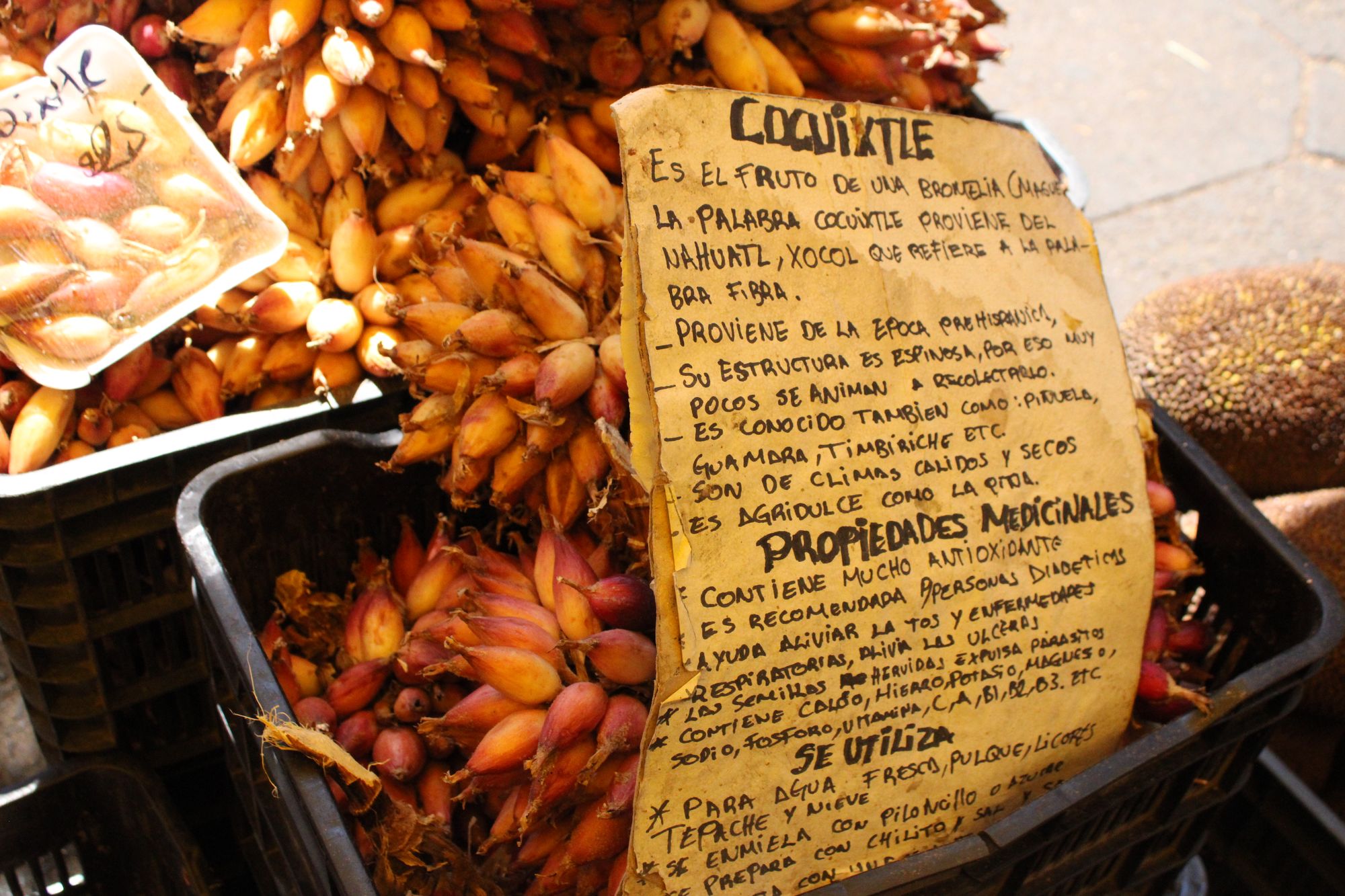 Handwritten sign about coquixtle fruit at the market