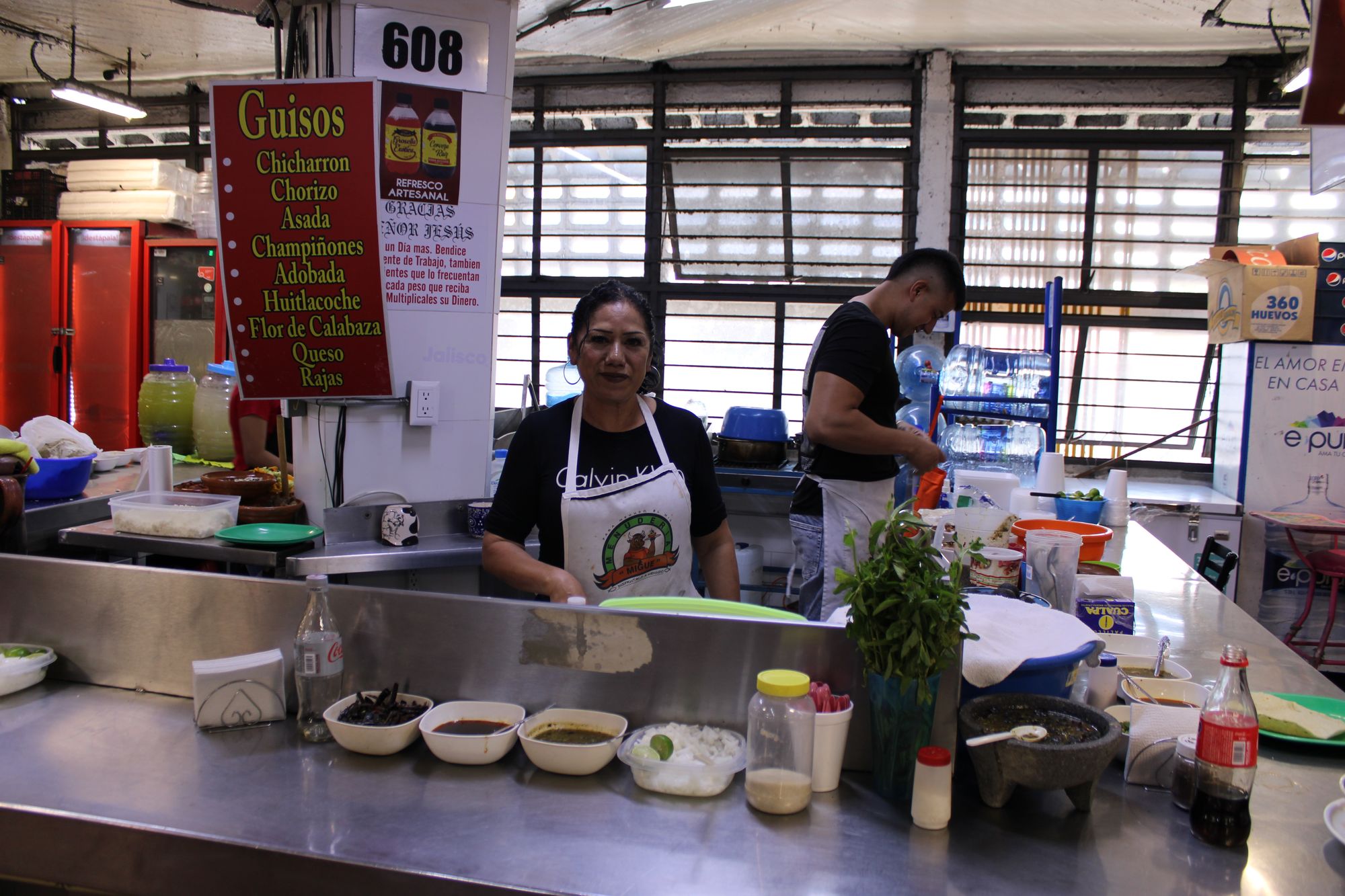 A cook at her guisos stand in Mercado San Juan de Dios