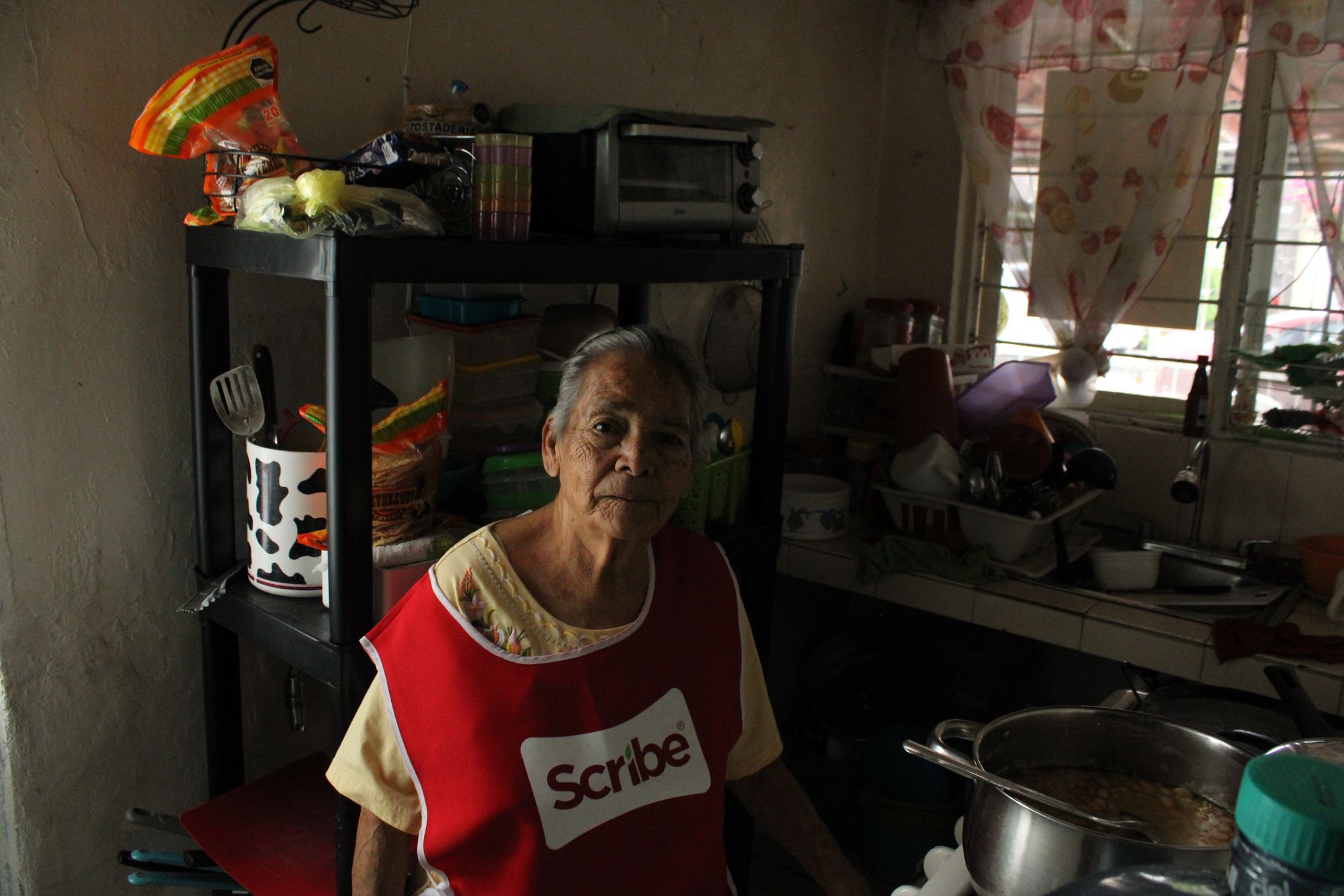 Virginia Morales seated in her kitchen