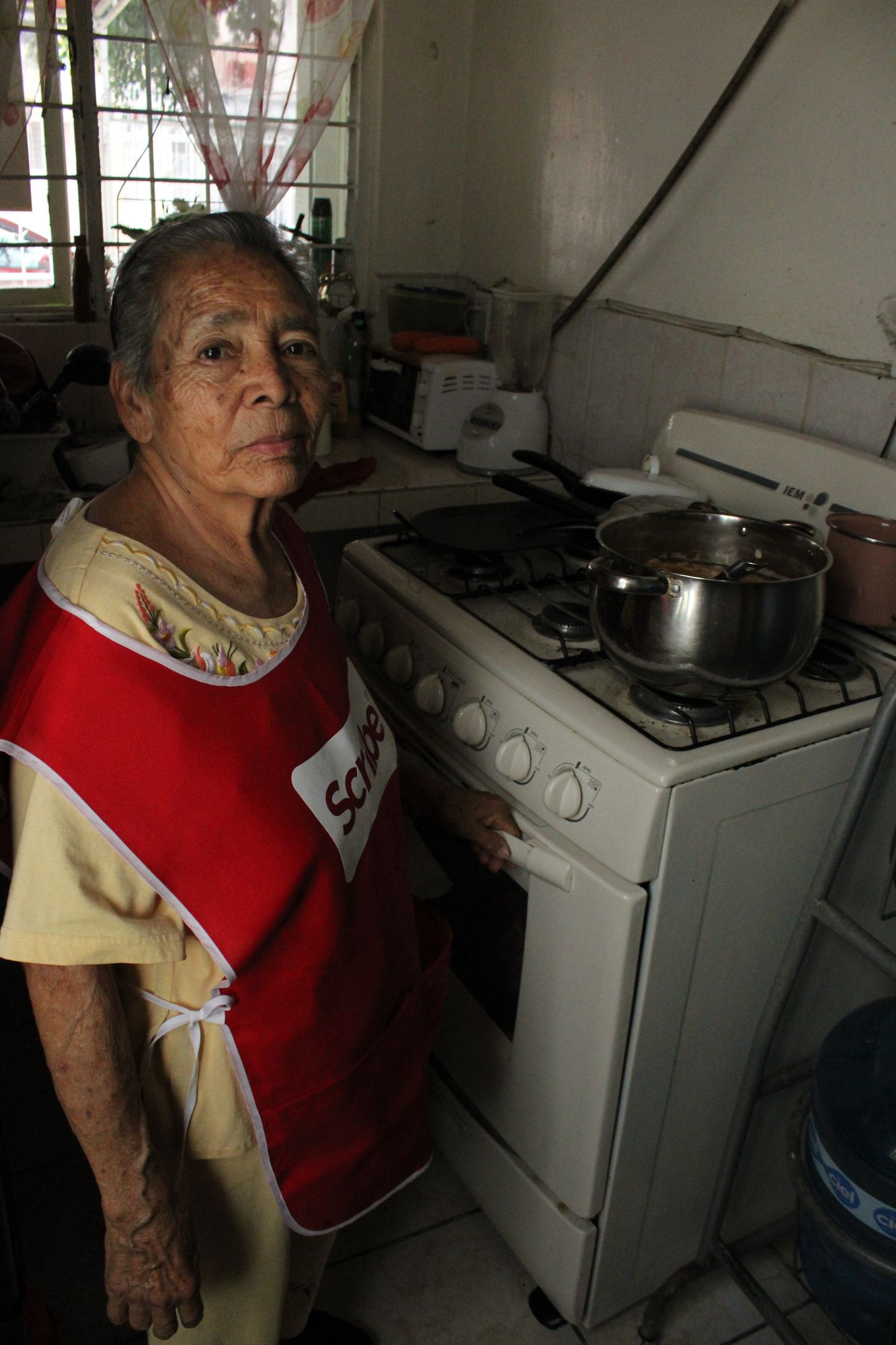 Virginia Morales standing by her stove