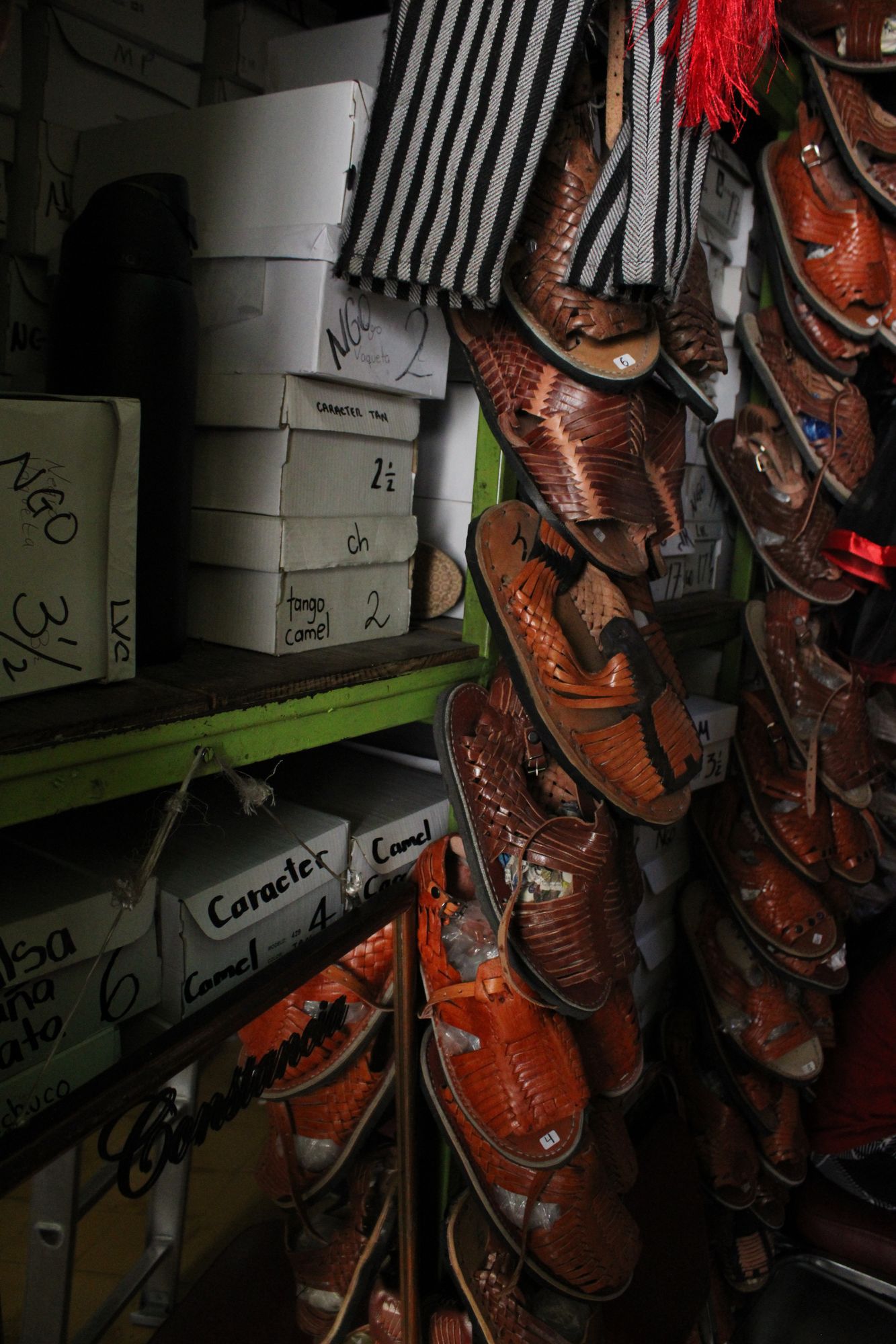 Rows of huaraches hanging in a zapatería